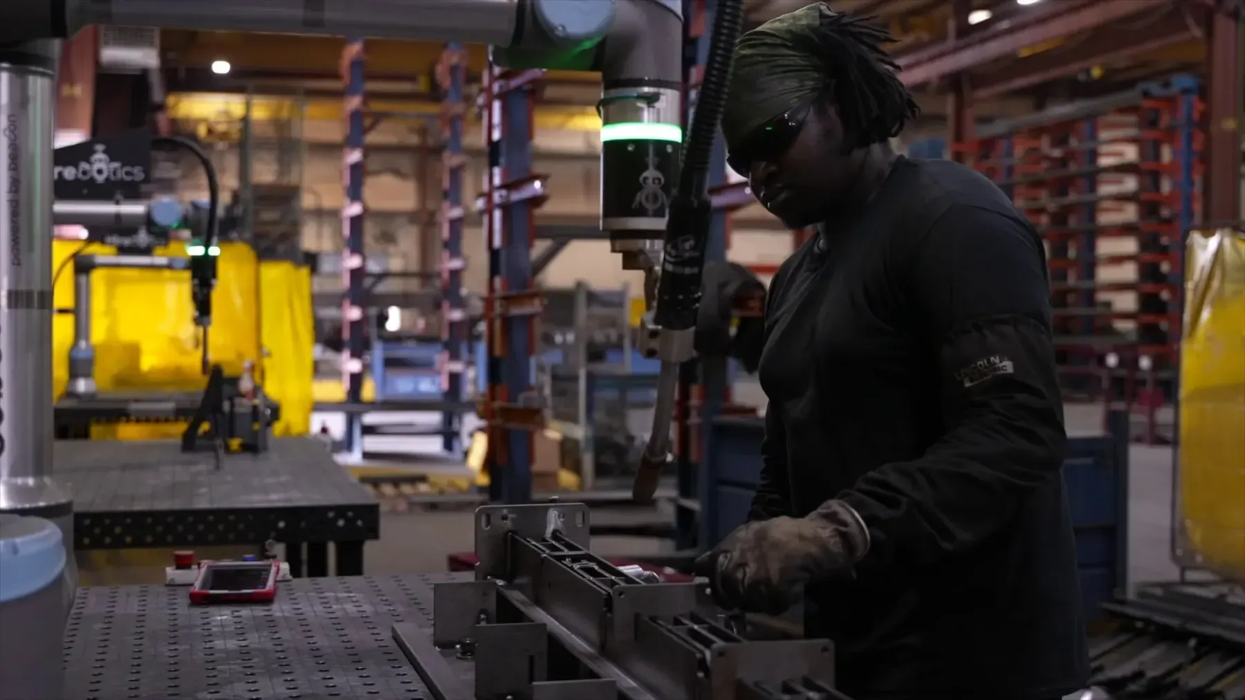 Fabricator working alongside a Beacon cobot welder